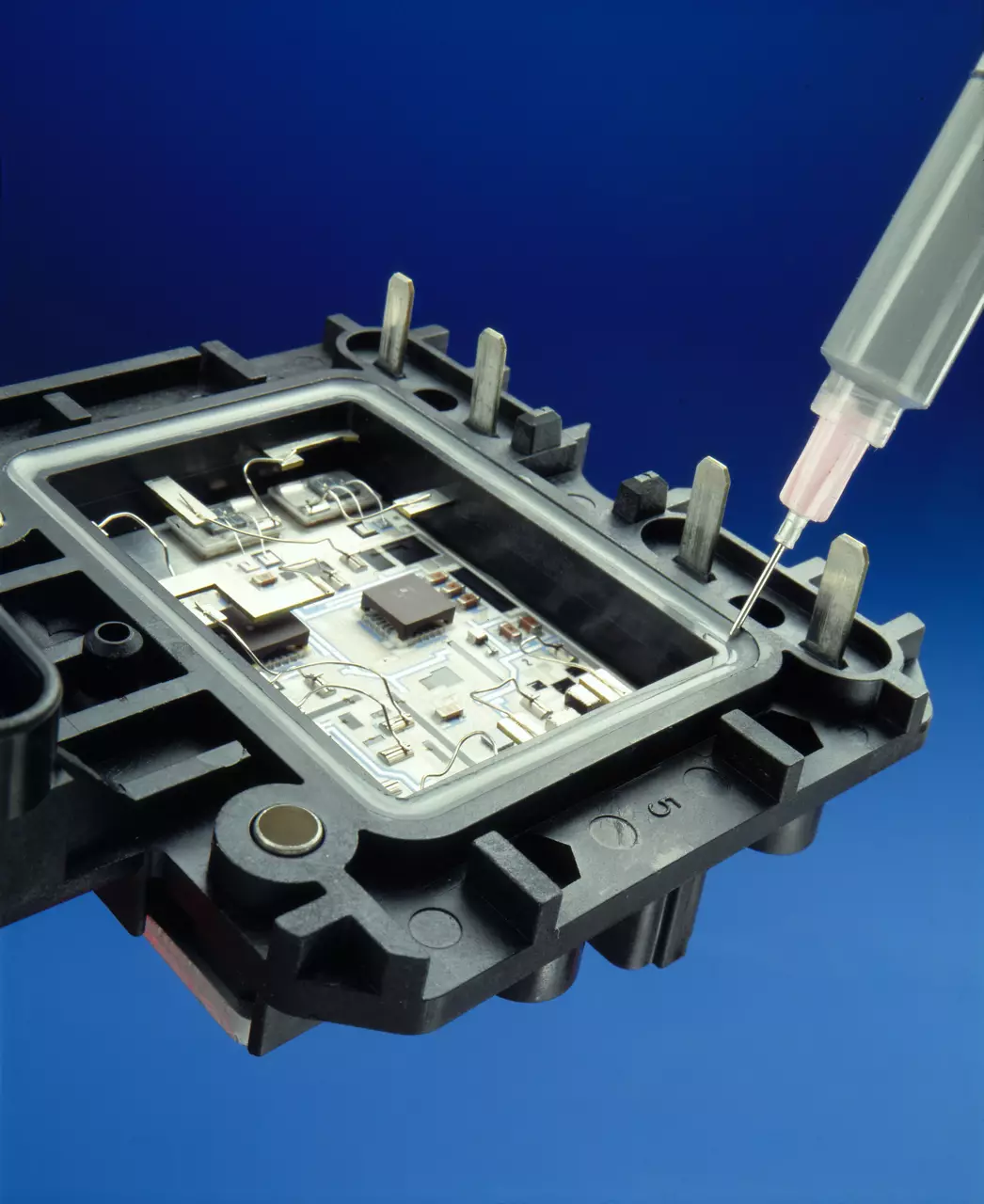 Needle injecting adhesive into plastic