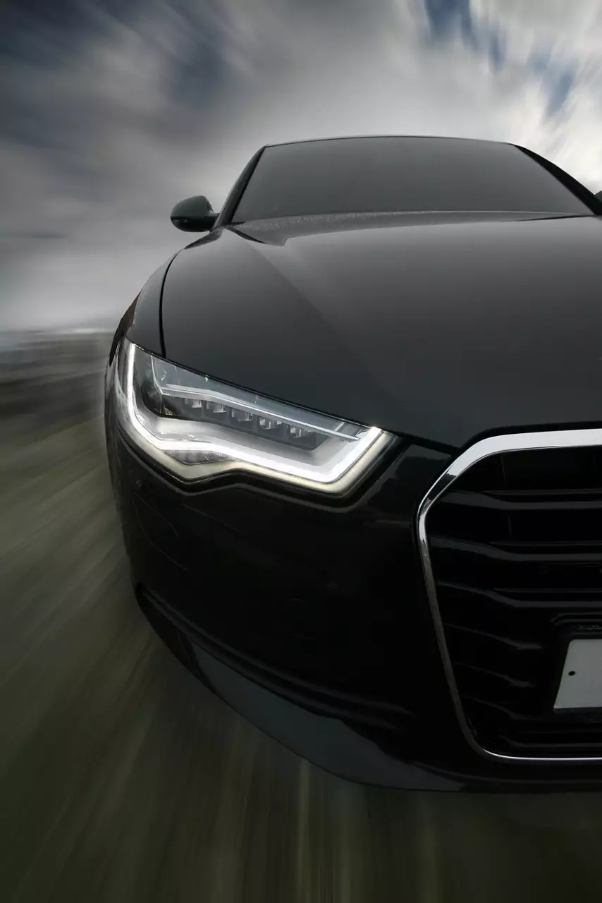 CREATOR: gd-jpeg v1.0 (using IJG JPEG v62), quality = 95 A black sportscar traveling down a road. / 123rf Image #12878715