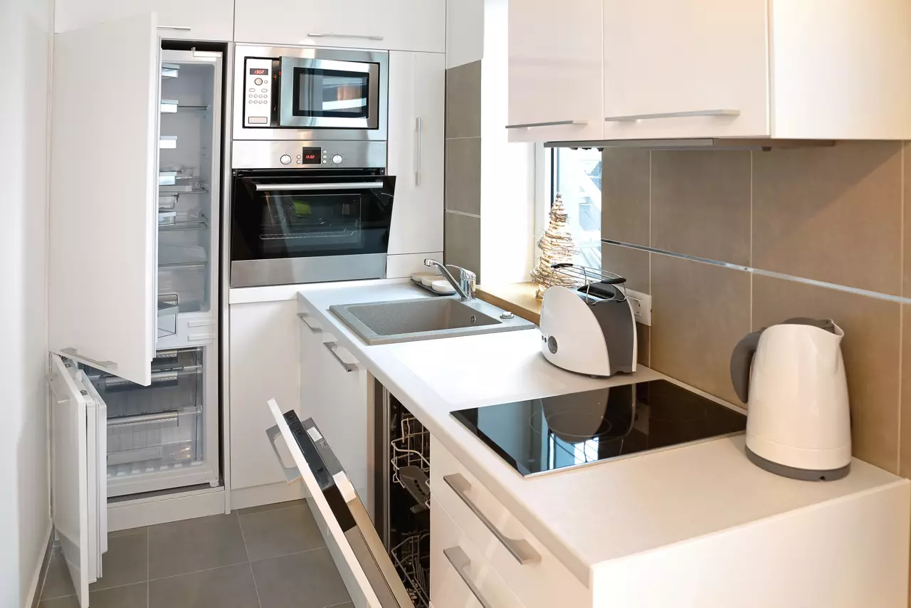 White modern kitchen with all appliance doors open