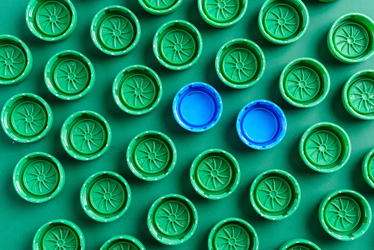 Plastic green caps from bottles and two blue caps