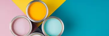 Four open cans of paint on bright symmetry