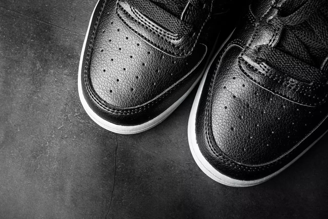 Black leather sports shoes close-up style.