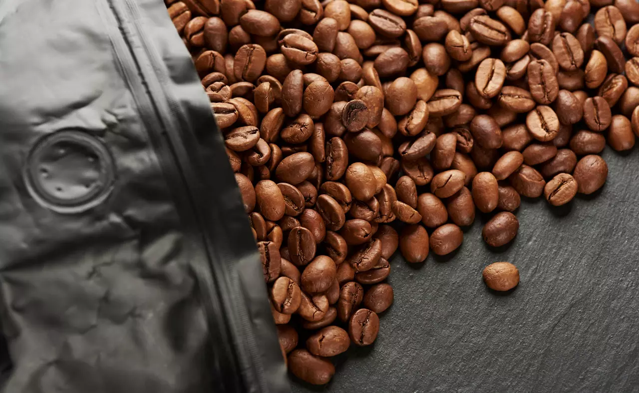 Fresh roasted coffee beans in shop package.