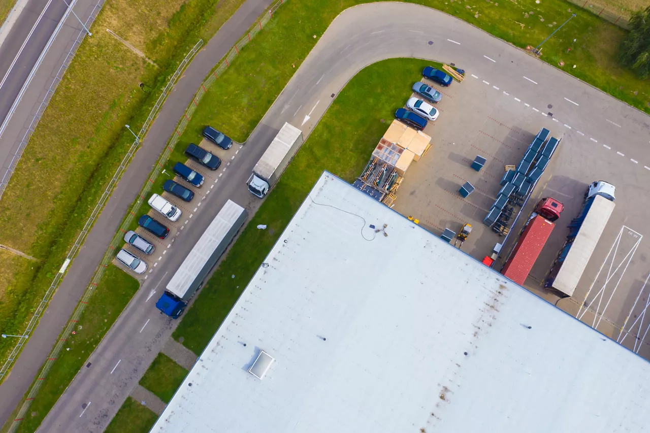 Birds eye view of warehouse roof and car park