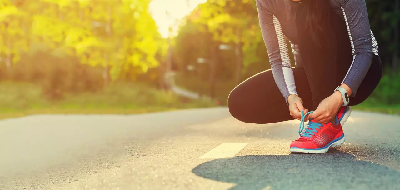 Female runner tying her shoes