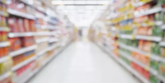 Empty Supermarket aisle shelves abstract blur defocused business background