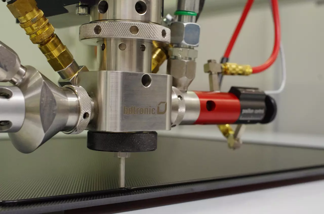 Silicone gray foam being dispensed in groove by machine