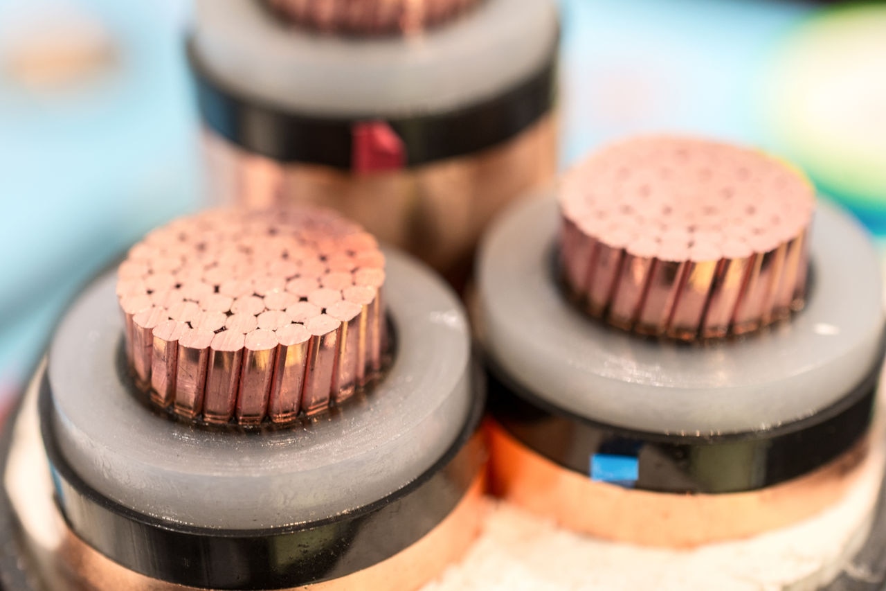 Cross section of high-voltage cable. Thick copper veins are surrounded by a thick layer of polymer insulation.
