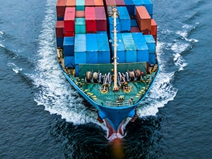Cargo ship sails across ocean