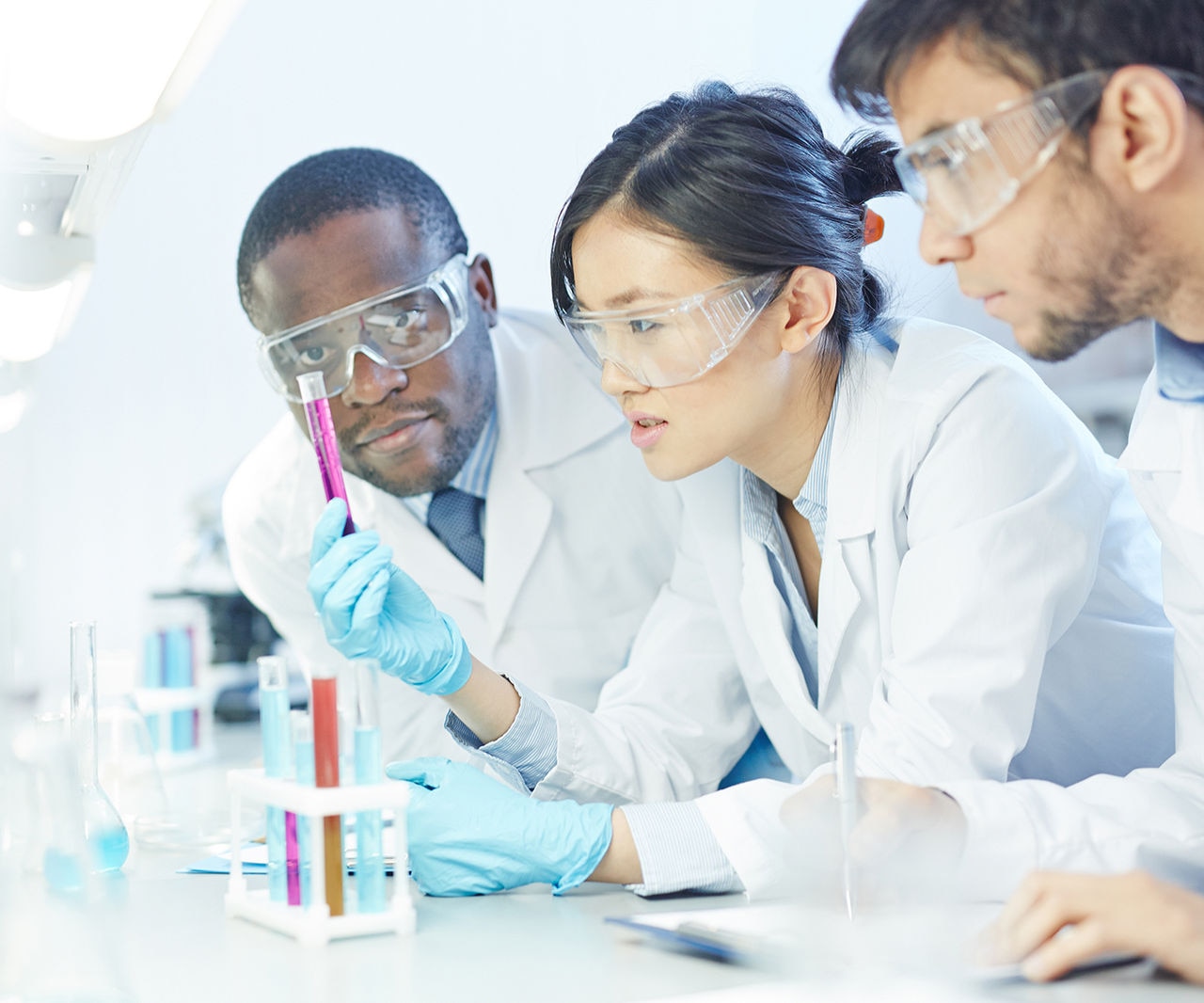 Group of scientists studying reaction of some chemical