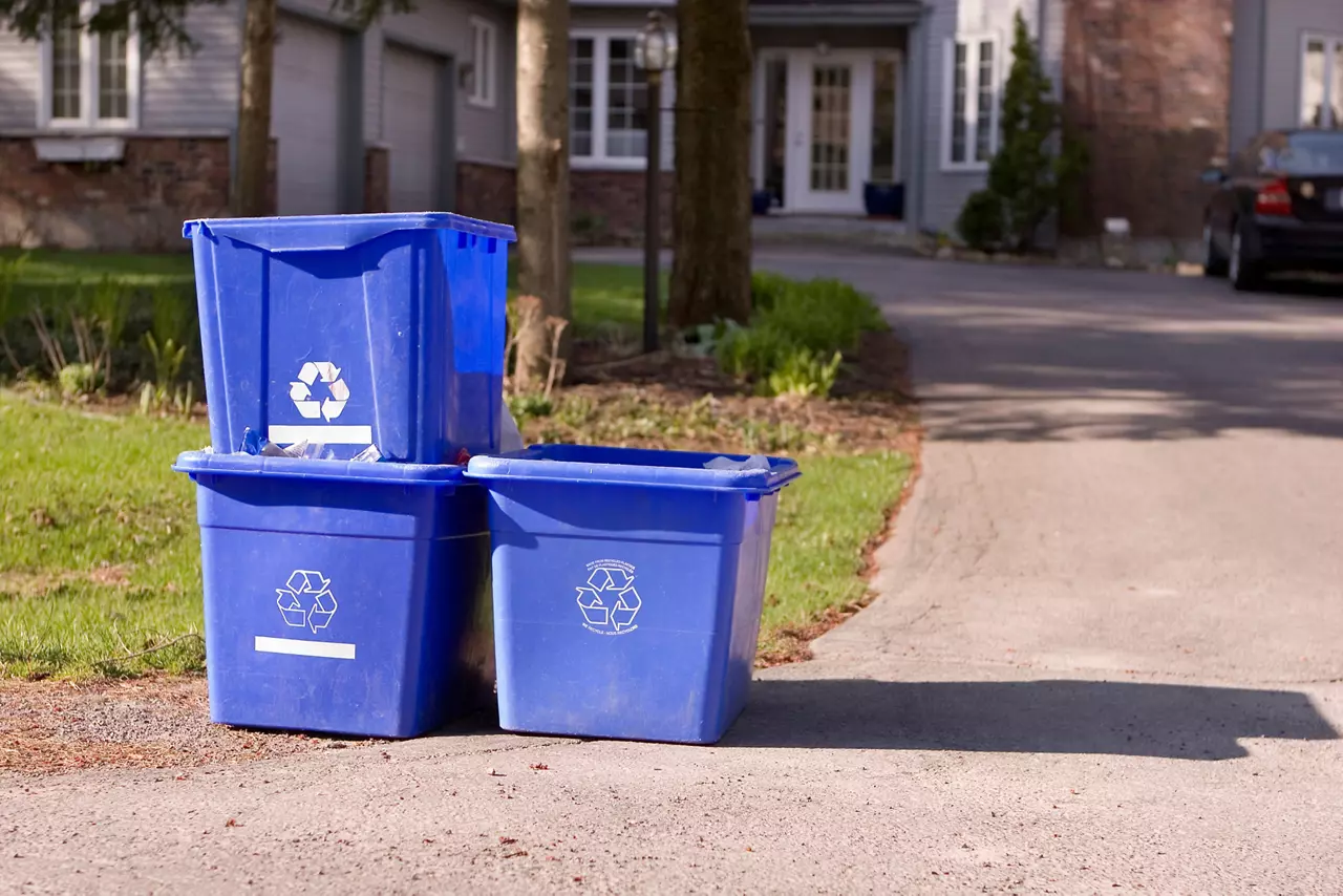 Recycling bins in front of a home.